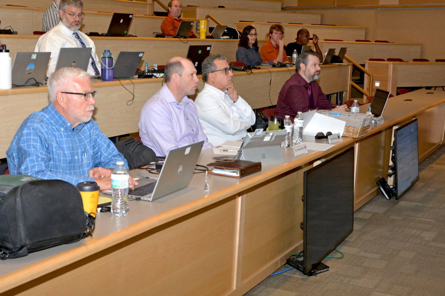 The judges asking the presenting group questions.